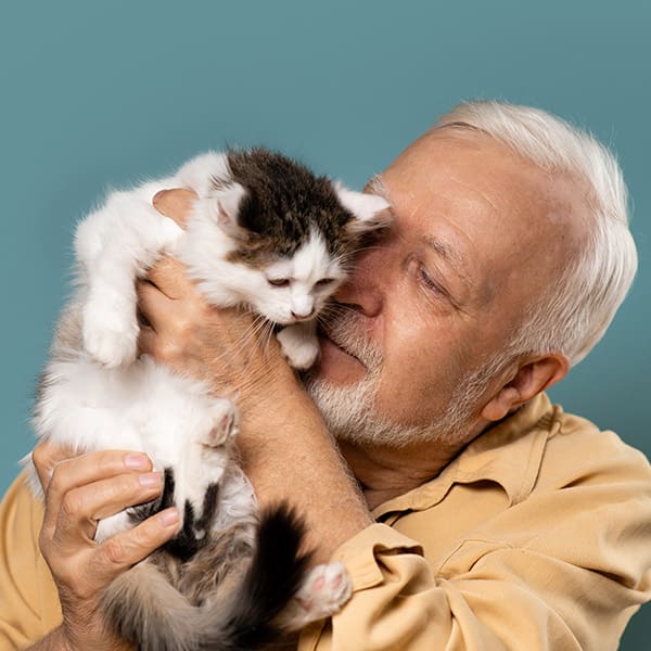 Older Gentleman Holding Kitten