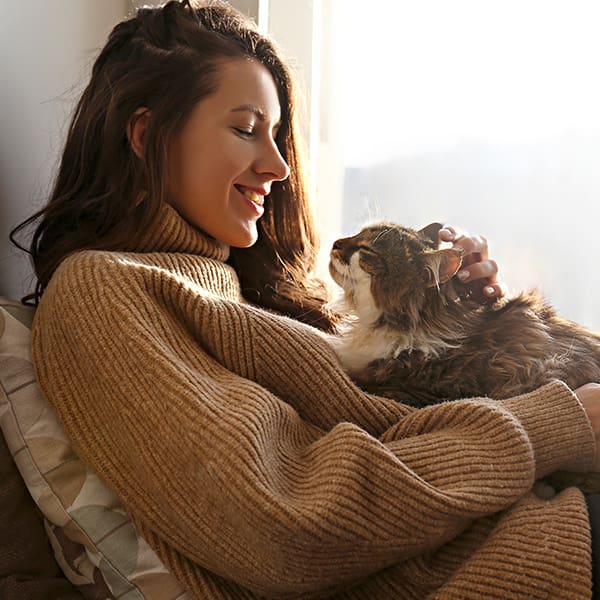 Woman With Cat Laying On Her Looking At Each Other